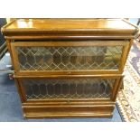 An oak Globe Wernicke two section bookcase with labels, and lidded glazed up and over doors.