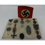 Collection of German WWII badges and medallions (13) and a German sleeve band