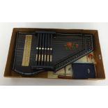 An original auto harp, boxed.