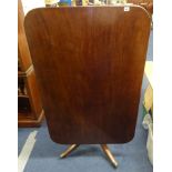 A 19th Century mahogany breakfast table, the rectangular top with reeded edge over a pencil base