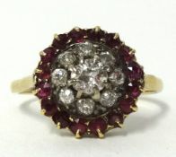 An antique diamond and ruby cluster ring set in yellow metal (unhallmarked),