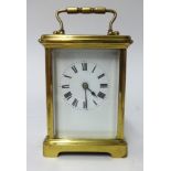 A French brass cased carriage clock, platform escapement, key wind, the white enamel dial set with