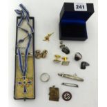 A German enamelled mothers cross inscribed '10th December 1930', cased, a U-boat tie clip, a