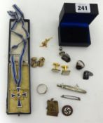 A German enamelled mothers cross inscribed '10th December 1930', cased, a U-boat tie clip, a