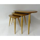 Ercol, a nest of three light elm 'pebble' tables (3).