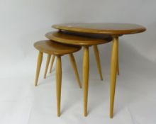 Ercol, a nest of three light elm 'pebble' tables (3).