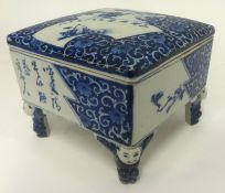 An unusual blue and white box of Chinese design decorated interior on four legs with figures