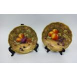 Two Royal Worcester fruit painted cabinet plates by P. Lowe, decorated with peaches and grapes
