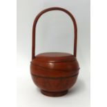 A Chinese red painted wood food carry pot, height 47cm