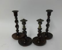 Two pairs of Barley twist oak candlesticks (4).