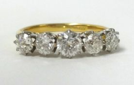 An 18ct 5 stone diamond ring, set in yellow gold, finger size M.