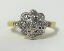 An 18ct diamond cluster ring, finger size N.