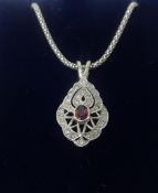 An 18ct ruby and diamond white gold pendant and chain.
