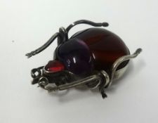 A red amber and silver bug, length 40mm.