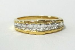 An 18ct Millennium cut diamond ring, set with 9 diamonds, finger size M.