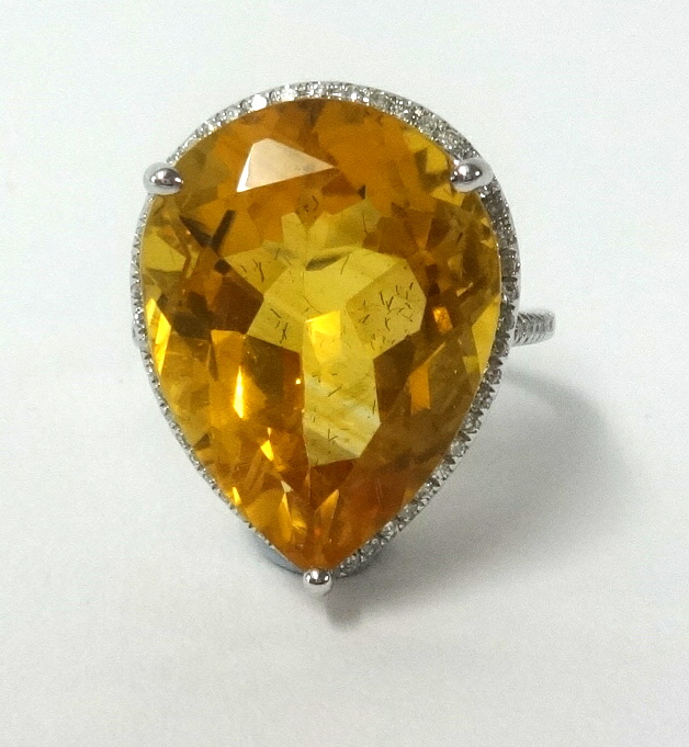 A 14k white gold and diamond set ring set with a pear shape yellow citrine approx .13ct diamonds
