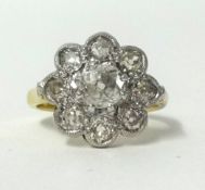 An 18ct diamond cluster ring, finger size M.