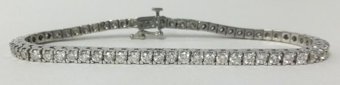 A fine 18ct white gold diamond line bracelet, approx 4.50cts of round cut diamonds.