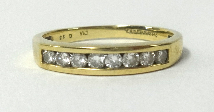 A 9ct yellow gold eternity ring, channel set with 8 round cut diamonds, finger size N.