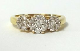 An 18ct diamond triple cluster ring, finger size M.