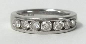 A platinum half band diamond eternity ring, set with 7 round cut diamonds.
