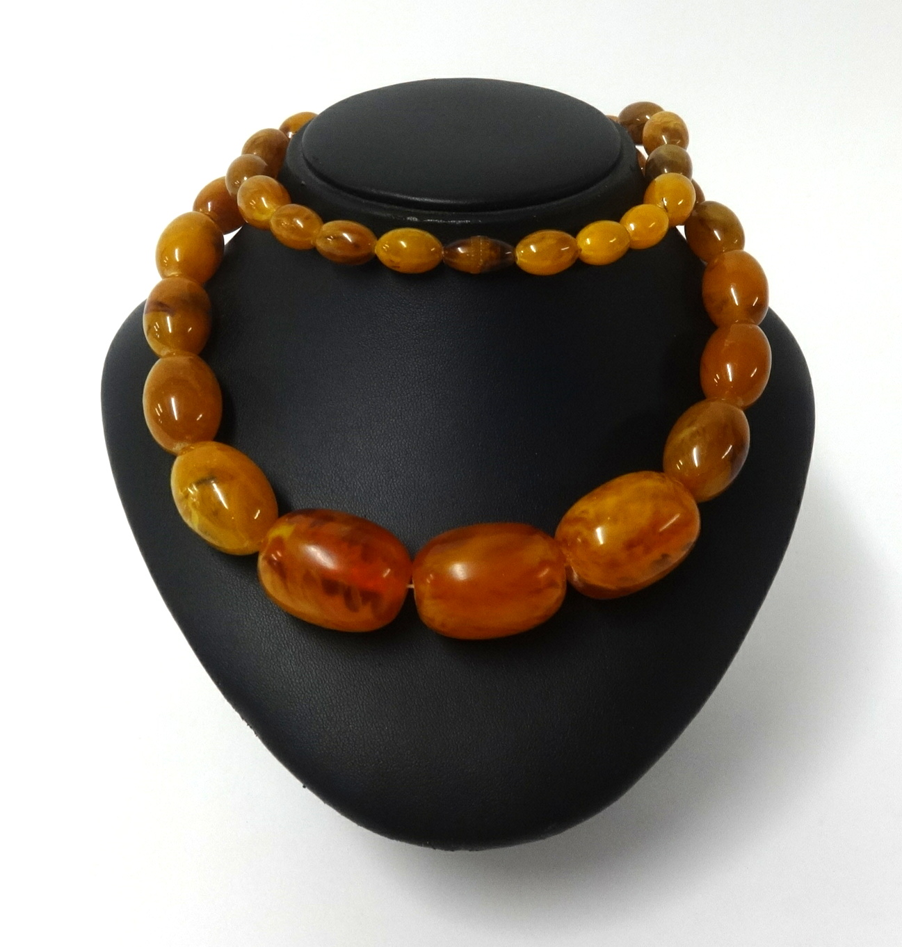 An amber style necklace, graduated beads, approx 74cm long, 114gms.