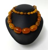 An amber style necklace, graduated beads, approx 74cm long, 114gms.