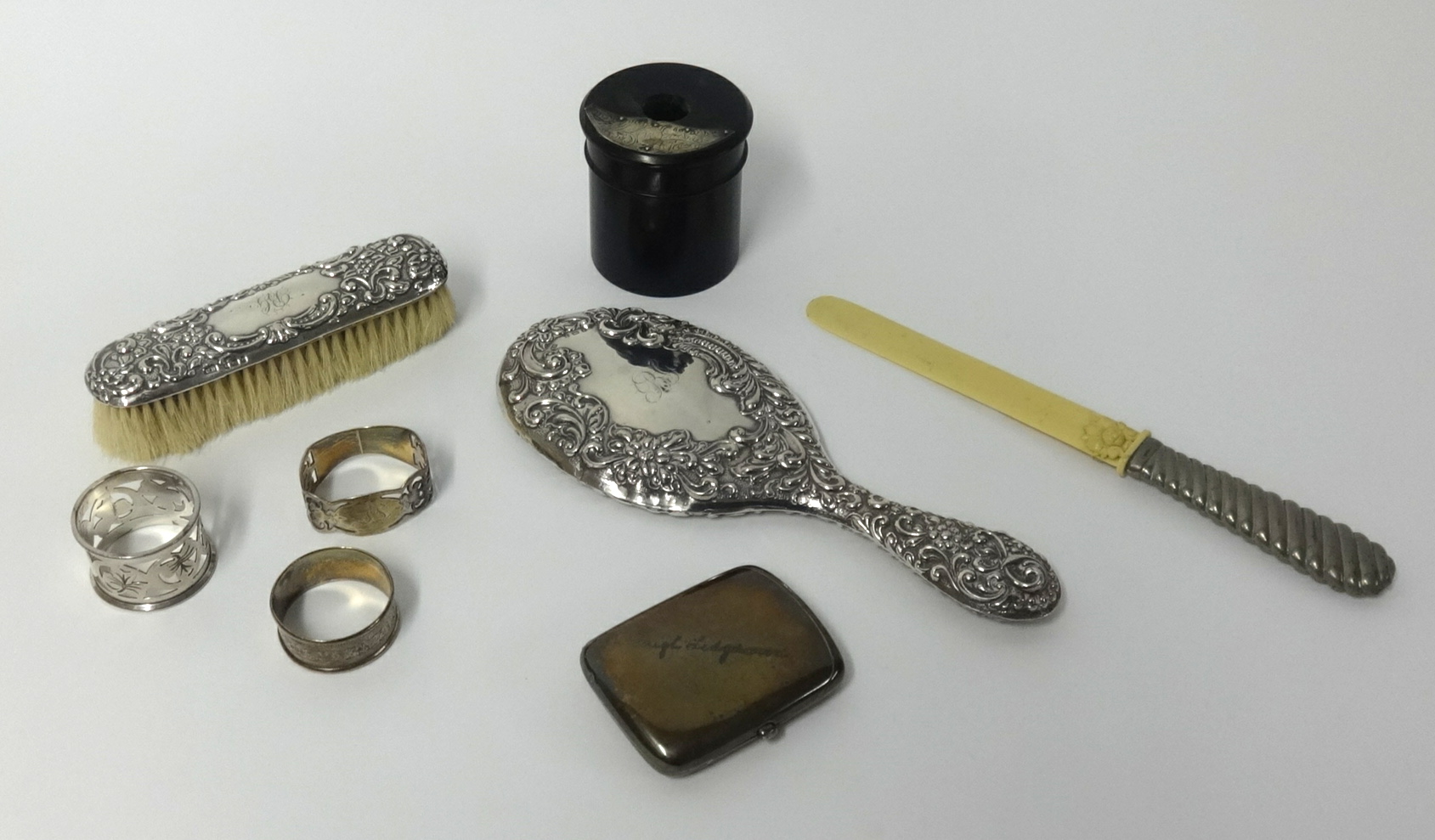 Various silver wares including silver cigarette case, silver back dressing table mirror, 3 napkin