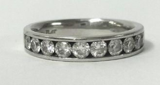 A platinum half band diamond eternity ring, set with 10 round cut diamonds, if similar