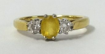 An 18ct yellow sapphire and diamond 3 stone ring.