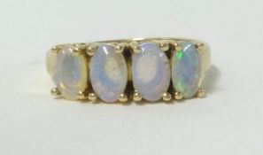 A 14ct opal four stone ring, with certificate of guarantee, finger size L.