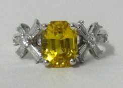 An 18ct yellow sapphire and diamond set pretty ring in white gold, finger size O.