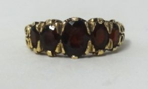 A 9ct garnet 5 stone ring, finger size K.