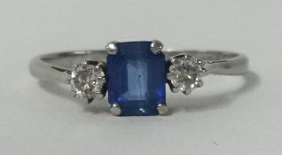 A platinum sapphire and diamond 3 stone ring.