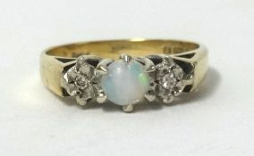A 9ct opal and diamond 3 stone ring, finger size K.