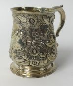 A Georgian silver christening mug richly embossed with decoration of flowers etc, approx 7.24ozs,