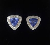 A pair of 14k white gold and diamond earrings set with trillion cut tanzanite's approx 1.21ct