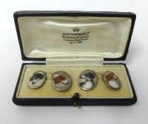 A pair of enamel and silver 'dog' cufflinks, boxed.