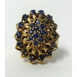 A large 9ct gold and sapphire cluster ring, finger size L, approx 7.3gms.