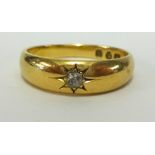 An 18ct gold ring set with a single diamond, approx 4.30gms.