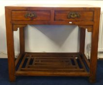 A Chinese pine two drawer side table with lower slat tier, width 96cm, depth 56cm