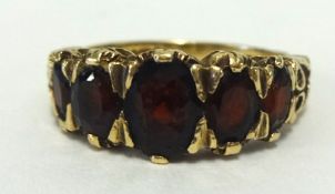 A 9ct garnet 5 stone ring, finger size K.