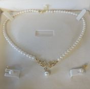 A modern 18ct gold and pearl necklace and earrings