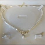 A modern 18ct gold and pearl necklace and earrings