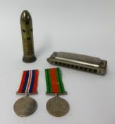 A pair of WWII medals awarded to H.E.Mitchell, Kingsbridge, boxed, also an harmonica and 'trench