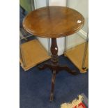 A 19th century mahogany tripod table on castors.