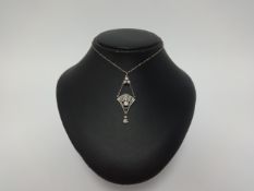 An art deco style diamond set drop pendant on fine chain, set with an arrangement of round and