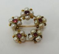 A pearl and ruby flower brooch, set in yellow metal, diameter approx 25mm.