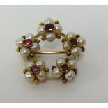 A pearl and ruby flower brooch, set in yellow metal, diameter approx 25mm.