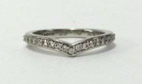 Rare Pink, a diamond and platinum half band eternity ring of wishbone design, finger size H.